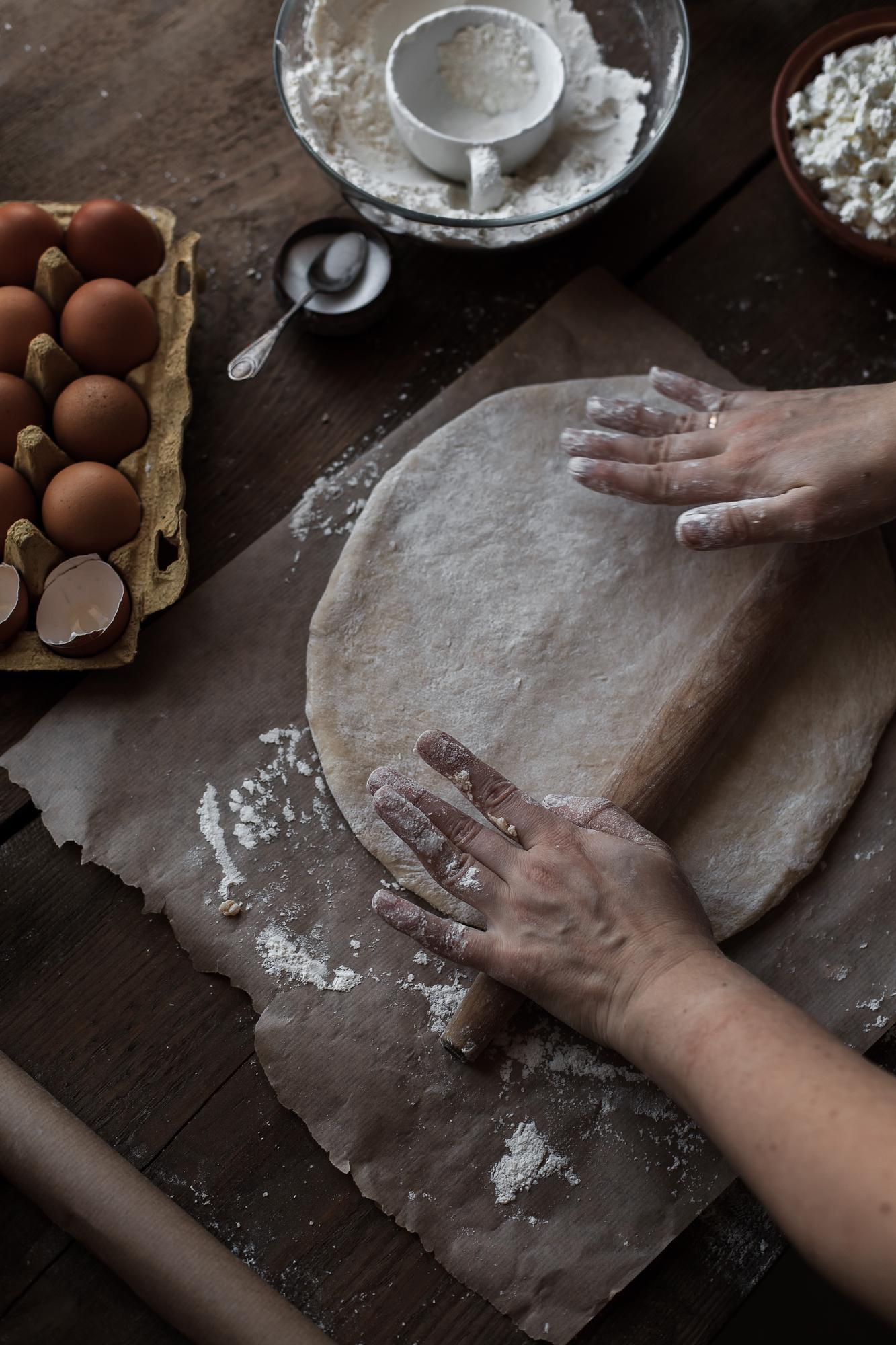 Close-up of hands kneading dough in a rustic kitchen
