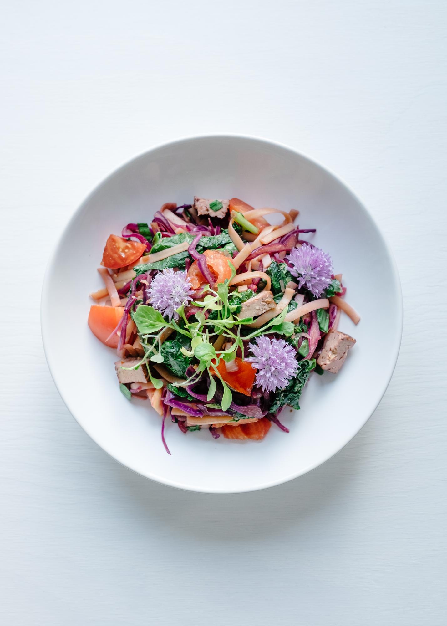 Large plated seasonal salad with edible flowers